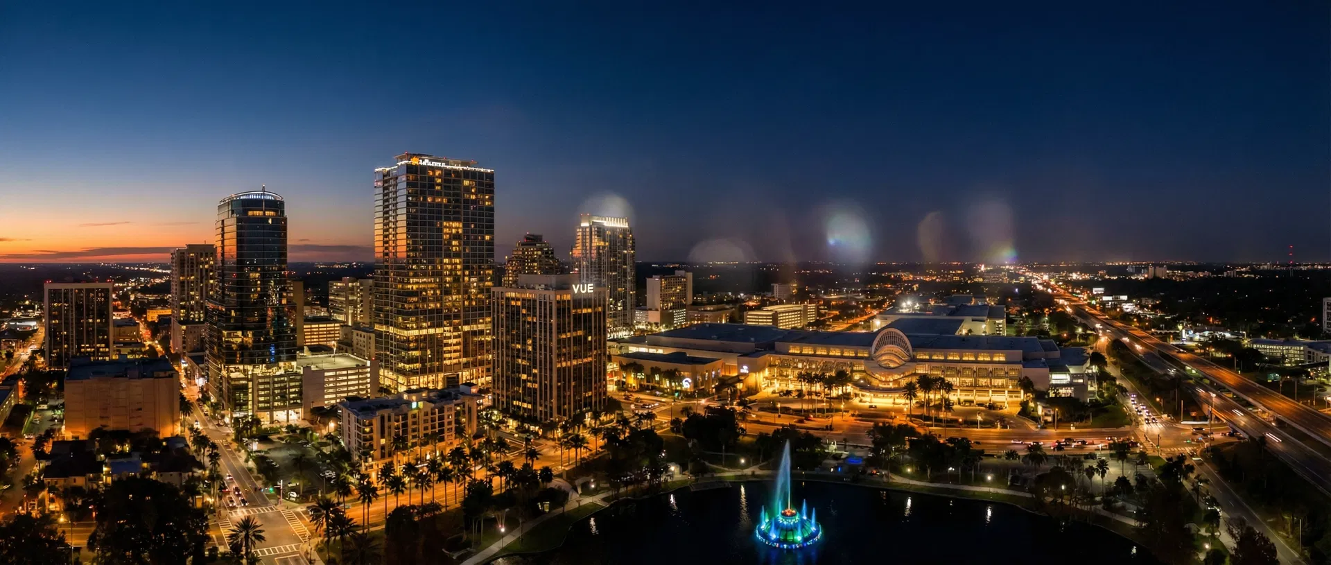 Orlando Florida skyline at twilight with Orange County Convention Center and Lake Eola fountain